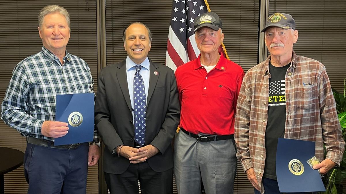 Congressman Krishnamoorthi presents Jon Fisher and Joseph Leuze with pins recognizing their service during the Vietnam War, and Douglas Beckmann (center) with his Bronze Star for his heroism in combat.