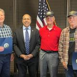 Congressman Krishnamoorthi presents Jon Fisher and Joseph Leuze with pins recognizing their service during the Vietnam War, and Douglas Beckmann (center) with his Bronze Star for his heroism in combat.